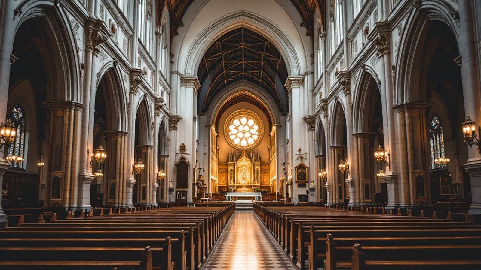 Wide shot of a church nave looking toward the altar in available light, empty or near-empty